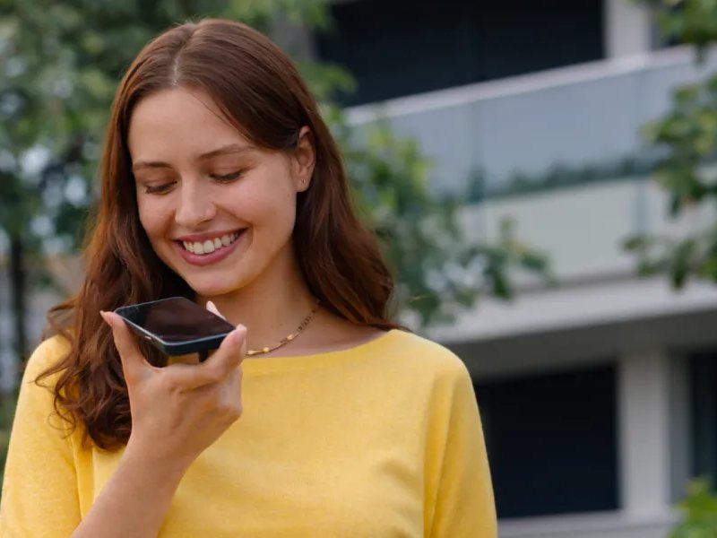 Customer receiving a message on her phone outdoors